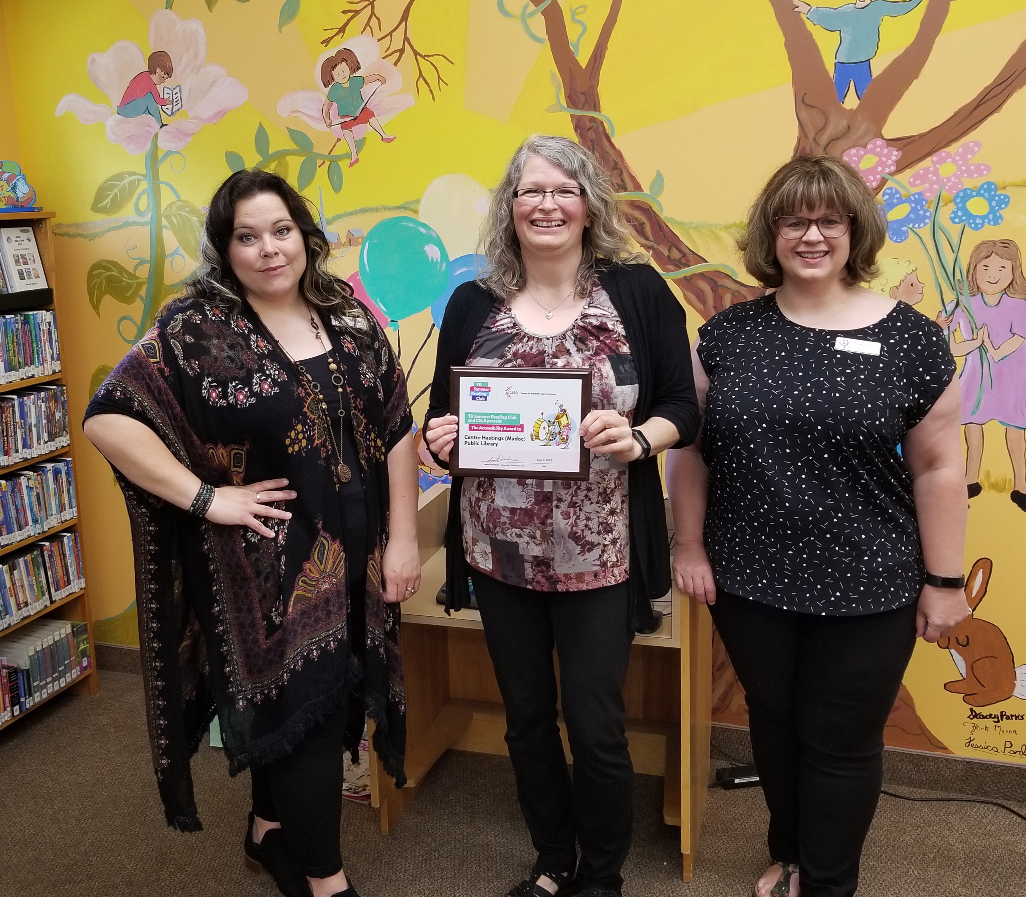 3 staff from Madoc Public Library holding TD Summer Reading Club Accessibility Award Winner plaque.